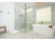 A modern bathroom with a glass-enclosed shower, marble accents, and a freestanding soaking tub at 1781 Pine Ave, Winter Park, FL 32789