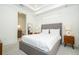 Bright bedroom showing a neutral color scheme, tray ceiling, with an en-suite bathroom at 1781 Pine Ave, Winter Park, FL 32789