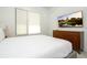 Cozy bedroom boasts a large window, TV, and stylish dresser, creating a comfortable retreat at 1781 Pine Ave, Winter Park, FL 32789