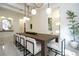 Dining room featuring a large wooden table, modern lighting, and glass-enclosed wine storage at 1781 Pine Ave, Winter Park, FL 32789