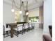 Bright dining area featuring a large wooden table, modern lighting, and neutral decor at 1781 Pine Ave, Winter Park, FL 32789