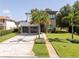 Modern home boasts a two-car garage, stone accents, and a meticulously landscaped front yard at 1781 Pine Ave, Winter Park, FL 32789