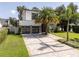 Contemporary home with a two-car garage, stone accents, well-kept landscaping and a paver driveway at 1781 Pine Ave, Winter Park, FL 32789
