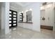 Foyer with a double door, a console table with decor, and a seating area with built-in storage and mirrors at 1781 Pine Ave, Winter Park, FL 32789