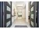 A grand foyer featuring high ceilings, modern lighting, and a view into the home's living spaces at 1781 Pine Ave, Winter Park, FL 32789