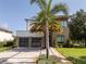 Contemporary home showcasing a two-car garage, and elegant landscaping with a well-manicured lawn at 1781 Pine Ave, Winter Park, FL 32789