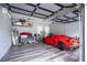 A well-organized garage interior with a red sports car parked inside on a grey floor at 1781 Pine Ave, Winter Park, FL 32789
