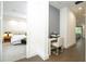 Hallway featuring hardwood floors and a workstation near a bedroom, and leading into a living area at 1781 Pine Ave, Winter Park, FL 32789