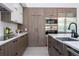 Stylish kitchen featuring wood-tone cabinets, stainless steel appliances, and modern fixtures at 1781 Pine Ave, Winter Park, FL 32789