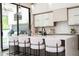 Kitchen island featuring barstool seating, pendant lighting, and modern white countertops at 1781 Pine Ave, Winter Park, FL 32789