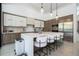 Modern kitchen with white cabinets, a center island with seating, and stainless steel appliances at 1781 Pine Ave, Winter Park, FL 32789