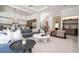 Spacious living room featuring a large sectional sofa, modern decor, and staircase nearby at 1781 Pine Ave, Winter Park, FL 32789