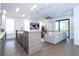 Open-concept living area with a modern kitchen island and a comfortable seating area at 1781 Pine Ave, Winter Park, FL 32789