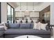 Comfortable living room with a large sectional sofa and modern kitchen island in the background at 1781 Pine Ave, Winter Park, FL 32789