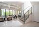 Spacious living area with modern furniture, large windows, and an open staircase at 1781 Pine Ave, Winter Park, FL 32789