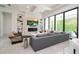 Modern living room with a large TV, fireplace, recessed lighting, and expansive windows at 1781 Pine Ave, Winter Park, FL 32789