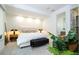 Bright bedroom featuring neutral decor, recessed lighting, a bench at the foot of the bed, and a view of a bathroom at 1781 Pine Ave, Winter Park, FL 32789