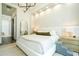 A spacious main bedroom with a king bed, textured walls, and a large mirror at 1781 Pine Ave, Winter Park, FL 32789