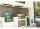 Outdoor kitchen with stylish black tile and stainless appliances at 1781 Pine Ave, Winter Park, FL 32789