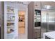 Walk-in pantry featuring well-organized shelving and ample storage space next to kitchen appliances at 1781 Pine Ave, Winter Park, FL 32789