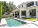 Backyard pool and outdoor living area featuring a covered patio and an outdoor kitchen at 1781 Pine Ave, Winter Park, FL 32789