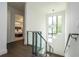 Contemporary staircase with glass railing and pendant lighting, leading to the upper level at 1781 Pine Ave, Winter Park, FL 32789