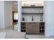 Stylish wet bar area with floating shelves, elegant glassware, and a sleek design at 1781 Pine Ave, Winter Park, FL 32789