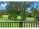 A large, green backyard area is visible from a black, wrought-iron balcony at 1812 Stoneywood Way, Apopka, FL 32712