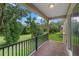 A shaded balcony looks out onto a beautifully landscaped, green backyard at 1812 Stoneywood Way, Apopka, FL 32712