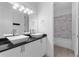 Stylish bathroom with double vessel sinks, modern lighting, and separate tub and shower at 1812 Stoneywood Way, Apopka, FL 32712