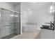 Bright bathroom with a glass-enclosed shower, soaking tub, and modern vessel sinks with sleek fixtures at 1812 Stoneywood Way, Apopka, FL 32712