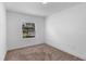 Neutral bedroom featuring carpeting, a window, and white trim at 1812 Stoneywood Way, Apopka, FL 32712