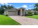 Lovely home with a brick driveway, two-car garage, and neatly landscaped yard at 1812 Stoneywood Way, Apopka, FL 32712