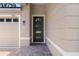 Charming front entrance with dark wood door and brick paved walkway at 1812 Stoneywood Way, Apopka, FL 32712