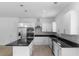 Modern kitchen with a stylish island, stainless steel appliances, white cabinets, and granite countertops at 1812 Stoneywood Way, Apopka, FL 32712