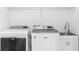 Convenient laundry room with utility sink and modern Maytag washer and dryer at 1812 Stoneywood Way, Apopka, FL 32712