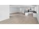 Spacious open-concept living room and kitchen with light wood-look flooring and modern design at 1812 Stoneywood Way, Apopka, FL 32712