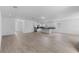 Open-concept living area with tile flooring, seamlessly connects to a modern kitchen, creating an inviting space at 1812 Stoneywood Way, Apopka, FL 32712