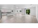 Spacious living area with sleek tile floors flowing into an open kitchen and a balcony with sliding doors at 1812 Stoneywood Way, Apopka, FL 32712