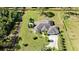 Sprawling home with mature landscaping, lengthy driveway, and attached two car garage sits on a lush, green lot at 19562 Majestic St, Orlando, FL 32833