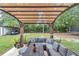 Covered back patio with comfortable seating and view of the spacious backyard at 2105 Ne 50Th Pl, Ocala, FL 34479