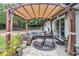 Inviting outdoor patio with a covered seating area, modern furnishings, and manicured landscaping at 2105 Ne 50Th Pl, Ocala, FL 34479
