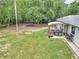 Large backyard with a patio area, trampoline, and mature trees at 2105 Ne 50Th Pl, Ocala, FL 34479