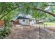 Wide angle view of the backyard featuring a chicken coop, patio and perimeter fencing at 2105 Ne 50Th Pl, Ocala, FL 34479