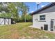 View of backyard featuring a shed, carport, golf cart, and the side of the house at 2105 Ne 50Th Pl, Ocala, FL 34479