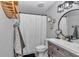 Charming bathroom featuring black hardware, modern vanity, patterned tile, and stylish fixtures at 2105 Ne 50Th Pl, Ocala, FL 34479