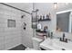 Modern bathroom with white subway tile shower, black fixtures, and decorative shelves at 2105 Ne 50Th Pl, Ocala, FL 34479