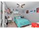 Comfortable bedroom featuring a ceiling fan, window, plush bed, and unique decor at 2105 Ne 50Th Pl, Ocala, FL 34479