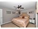 Bedroom with ceiling fan, carpet, neutral walls and stylish decor at 2105 Ne 50Th Pl, Ocala, FL 34479