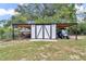 Backyard carport with boat and golf cart at 2105 Ne 50Th Pl, Ocala, FL 34479